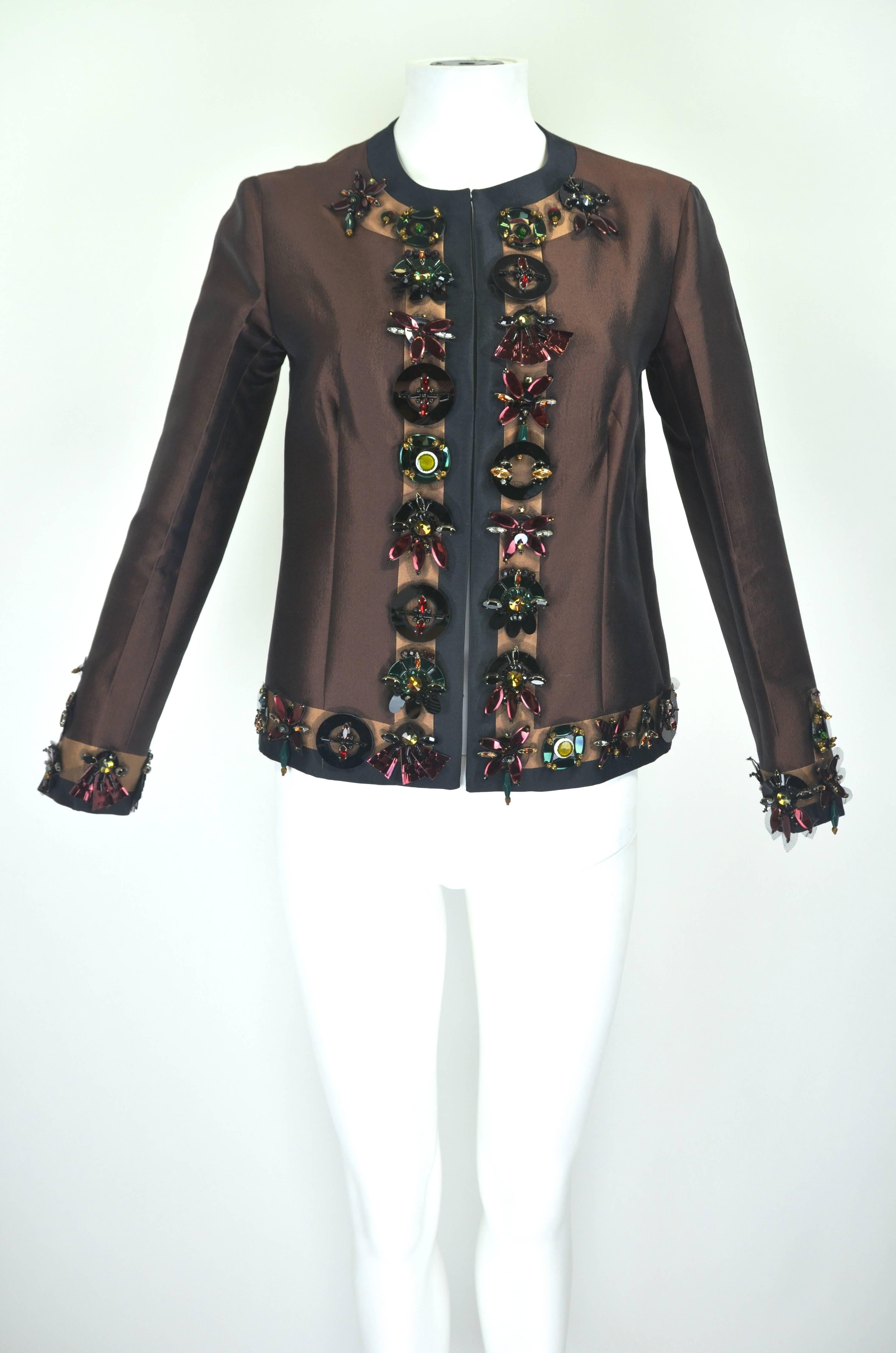 This gorgeous deep brown silk wool jacket from Prada features jeweltone oversize paillettes and rhinestones, adding texture to the graphic color palette. 

Measurements--
Bust: 34 inches
Sleeve Length: 21 inches
Length, Center Back to Hem: 21