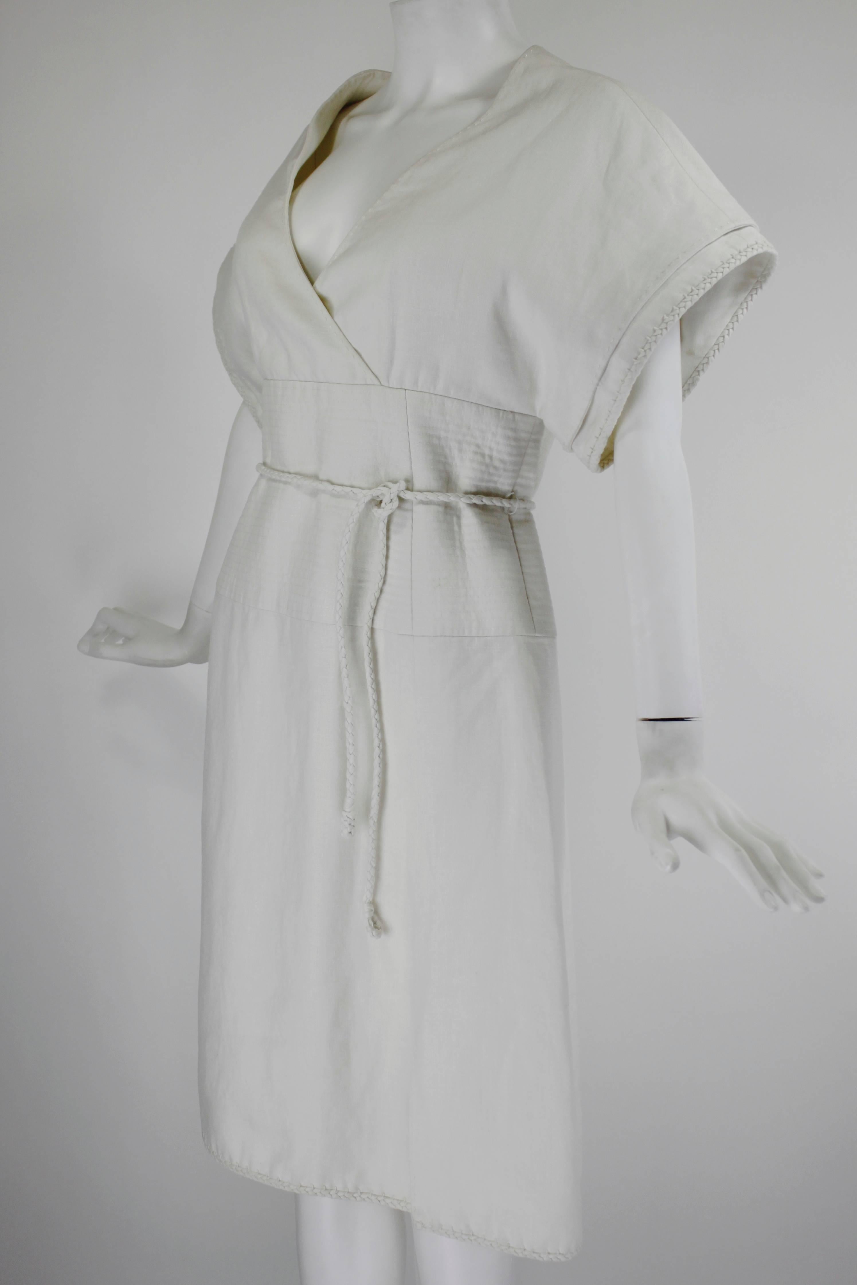 A beautifully tailored minimalist dress from master dressmaker Ralph Rucci. This dress--like most Rucci pieces--is all about the detail rounding out the simplicity of design. The hems of the dress are finished in beautifully braided rope, and the
