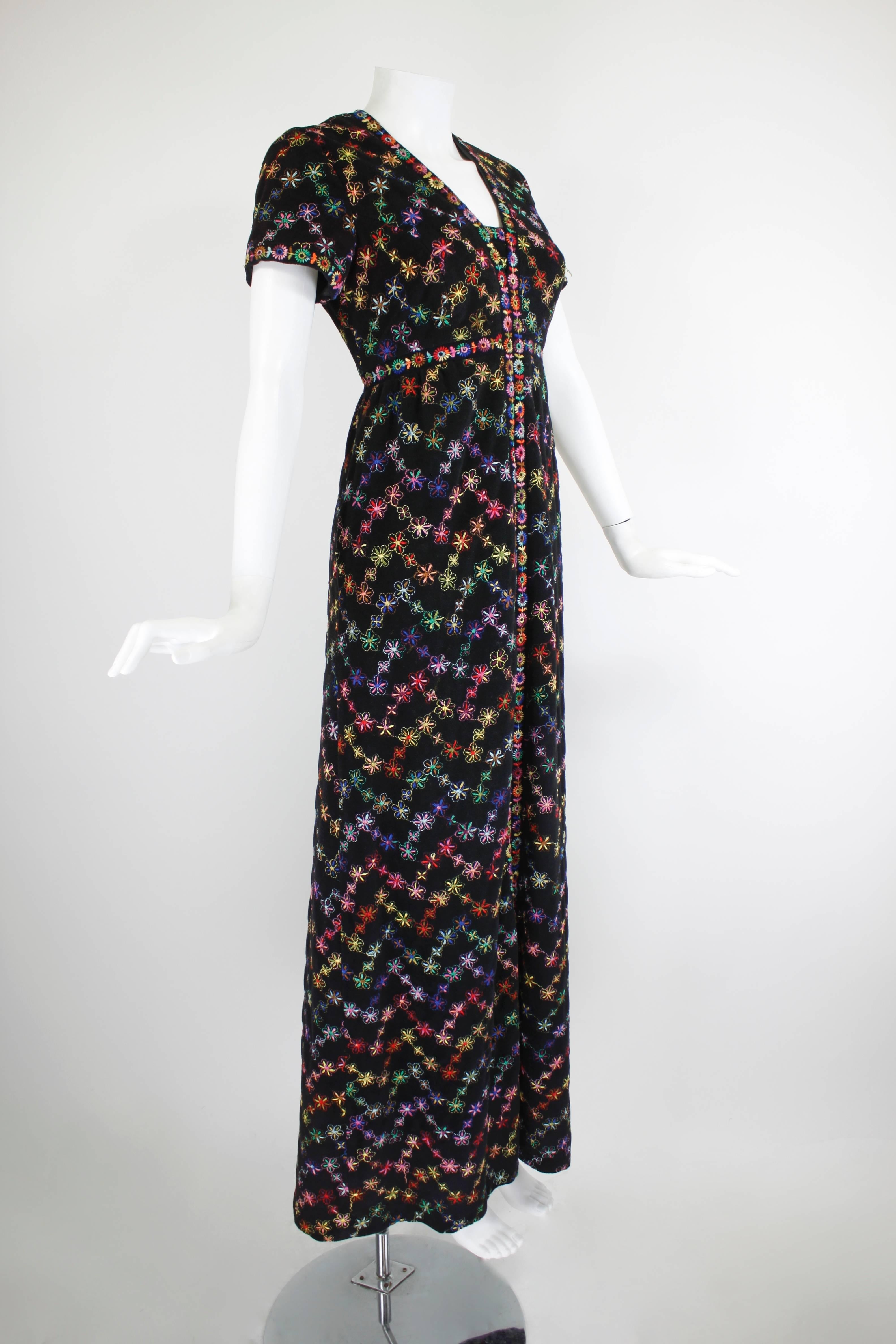 This fabulous maxi dress from the 70s, attributed to Sant' Angelo, is covered in beautiful rainbow spectrum floral embroidery. The column gown features and empire waist and cap sleeves. Attributed to Sant' Angelo.

-Fully lined
-Zips in