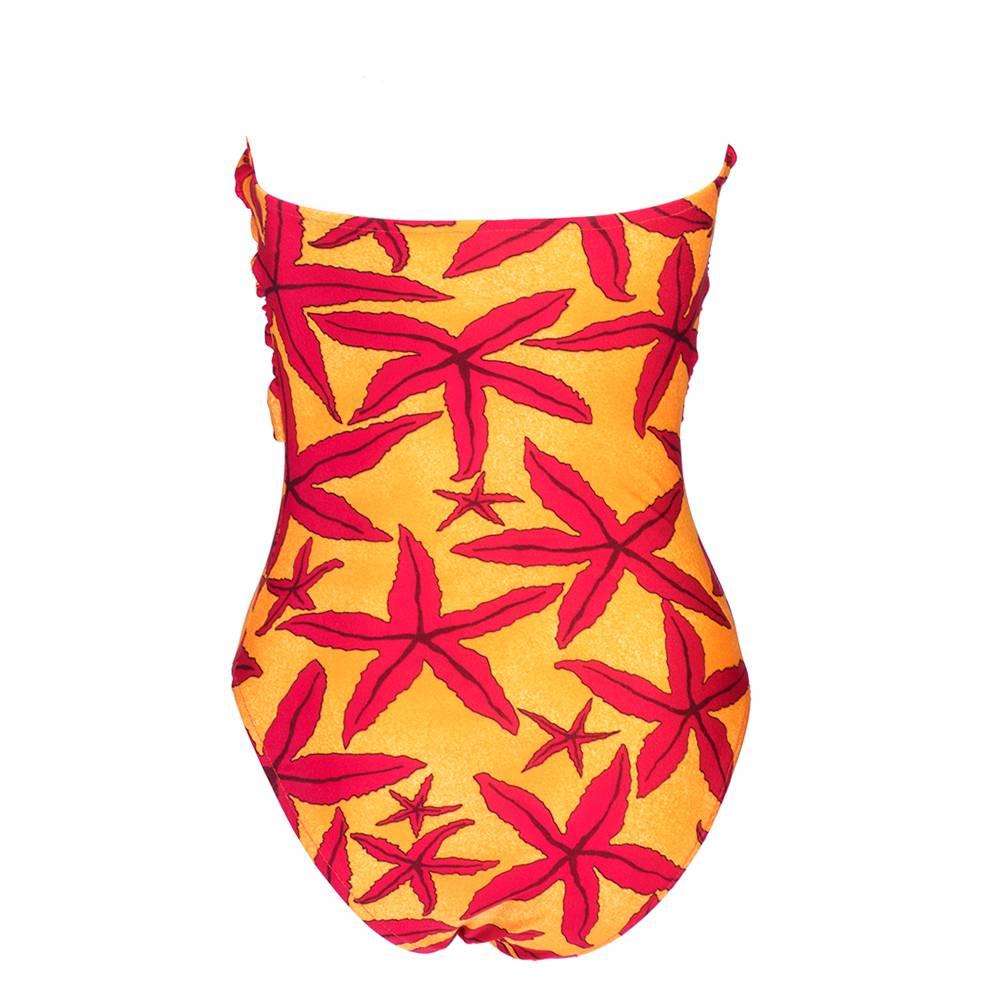 Maillot-style bathing suit. Strapless, with convertible bandeau wrap or halter neck. Orange and red starfish print. High-cut leg opening. Excellent condition. Labeled FR 42.

Size:  FR 42 / US 6