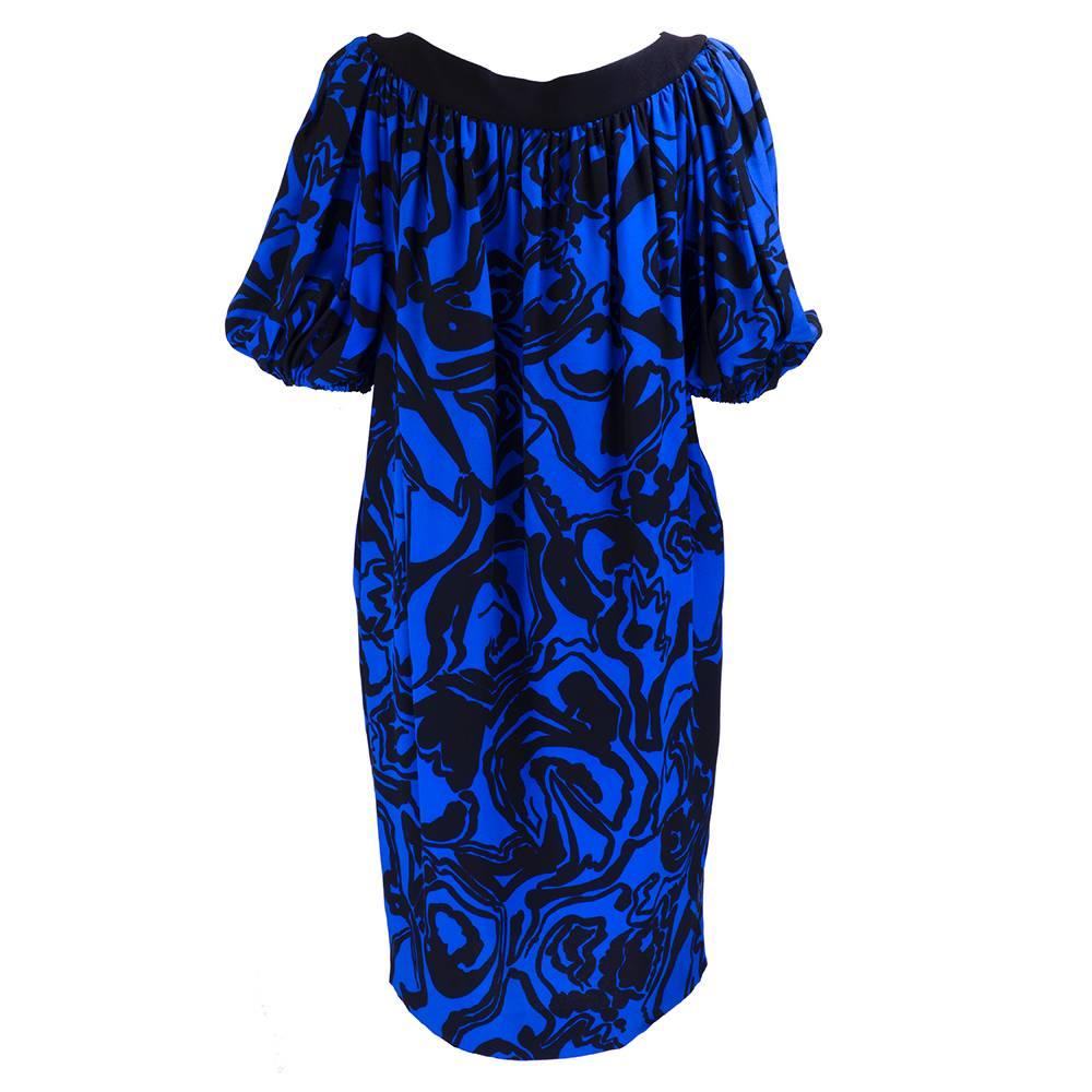 1980s iconic design Saint Laurent sack dress in a vibrant blue and black abstract painterly print. Elasticized poufed 3/4 sleeves with hidden side pockets. Great worn with or without a belt!