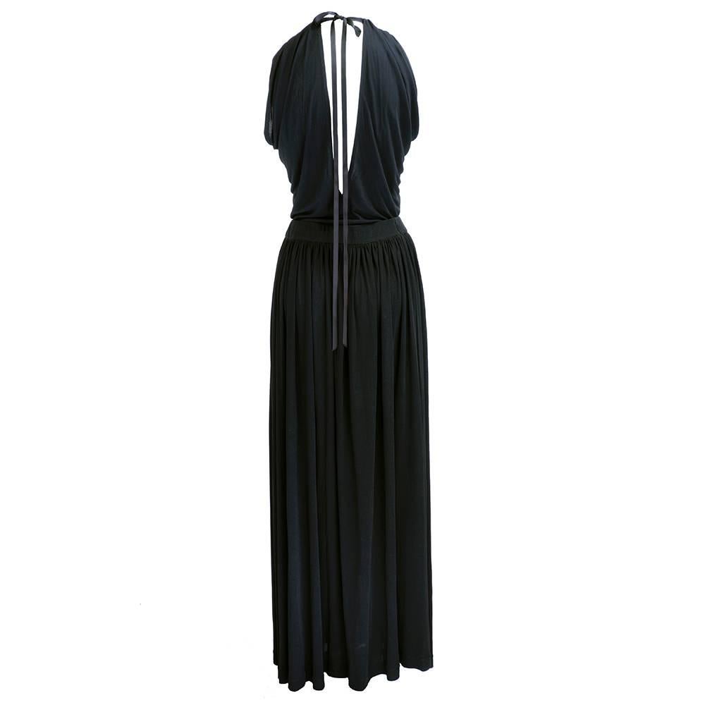 Classic 1970s saint Laurent jersey 2 piece ensemble consisting of super sexy drapy tank top and gathered waist full length wrap style skirt.  Skirt has expandable elastic waist  and daring high cut slit. Sizing is adjustable due to stretch, drape