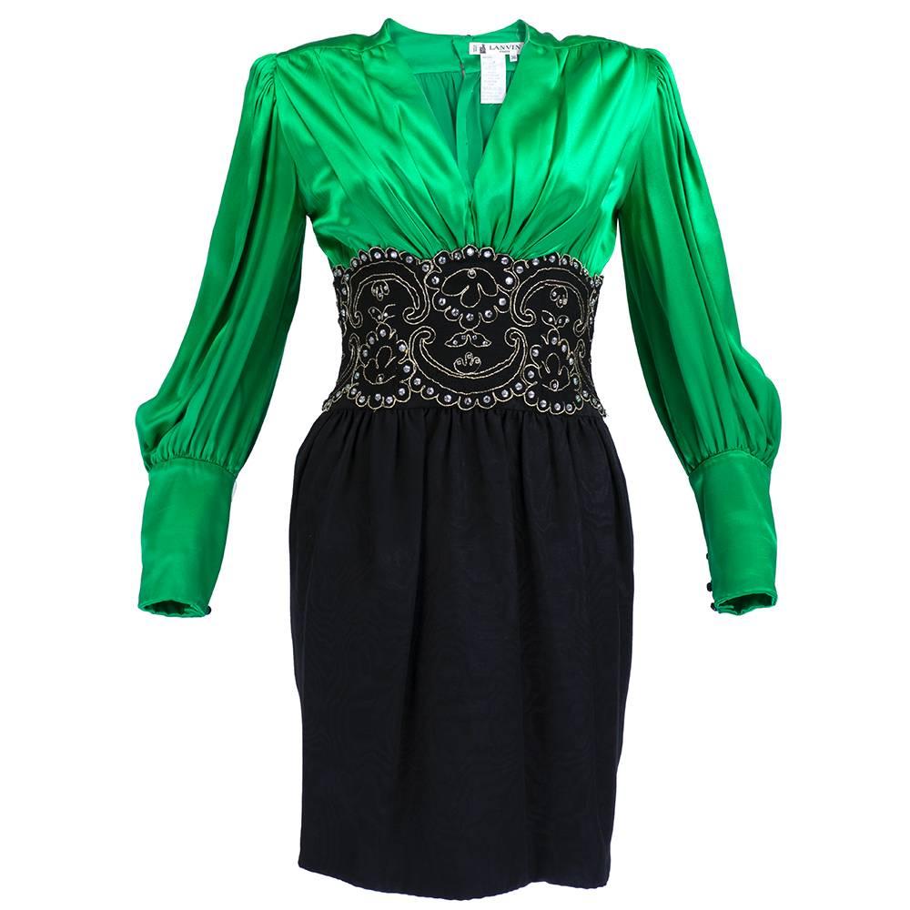 1990s Lanvin green and black silk body con cocktail dress with rhinestone encrusted lace wide cumberbund. Full sleeves with exaggerated cuffs and deep V neck with shirred waist on moire skirt.