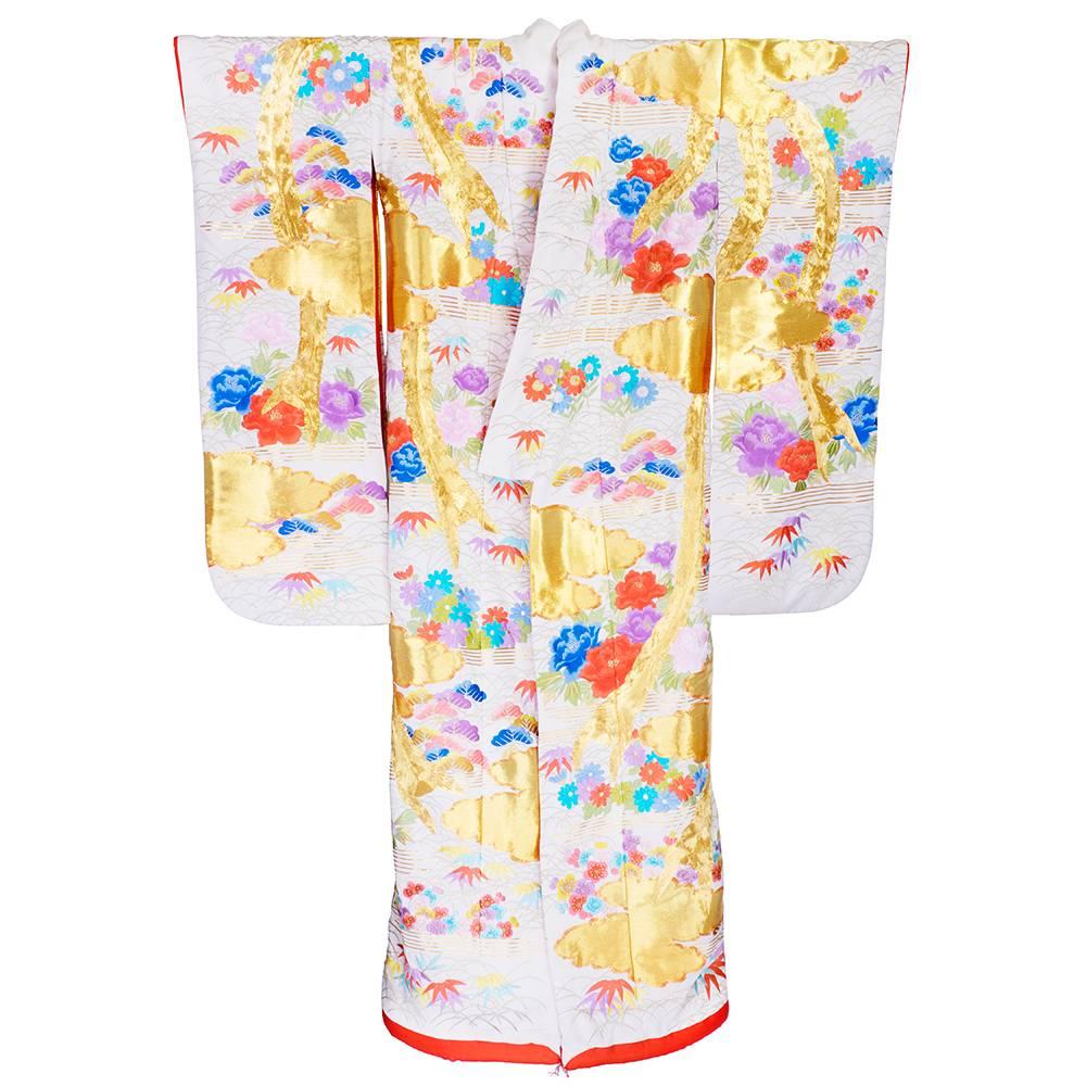 Japanese uchikake wedding kimono- Ivory silk embellished with an astonishing amount of gold embroidery. The couching embroidered on the phoenix was created by expert hands guiding a machine to sew on miles of thick golden thread. This creates a