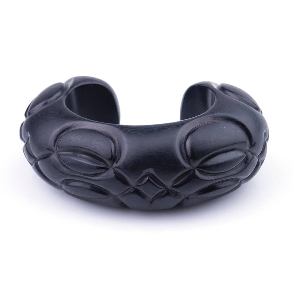 Contemporary carved ebony wood bracelet with matching button earrings by renowned jewelry designer Patricia Von Musulin. Substantially sized cuff with sterling silver backed button earrings. Truly a statement piece.