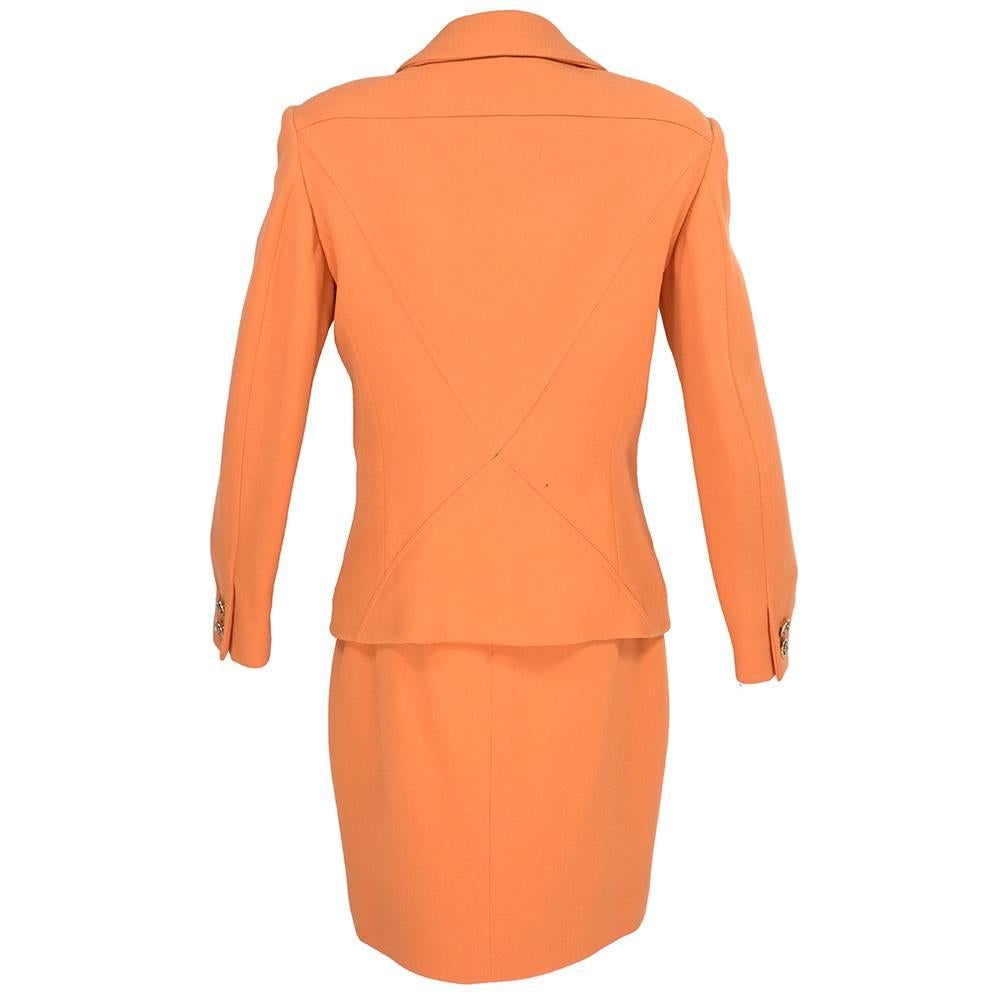 Lifetime iconic Versace two piece suit in bright tangerine with metal and leather accents in signature bondage style buckles. Elaborate detailing in collar, pockets and closures. Overall excellent condition except for missing the original leather