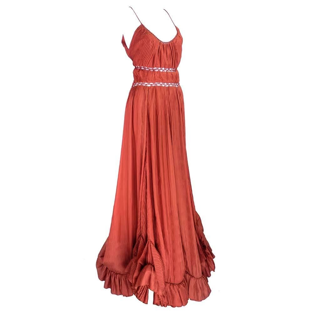 Early 2000's Zac Posen gown in russet colored silk. Elaborately detailed and pleated with peek-a-boo bands at waistline.  Sweeping full skirt with ruffled hem. New with tags.