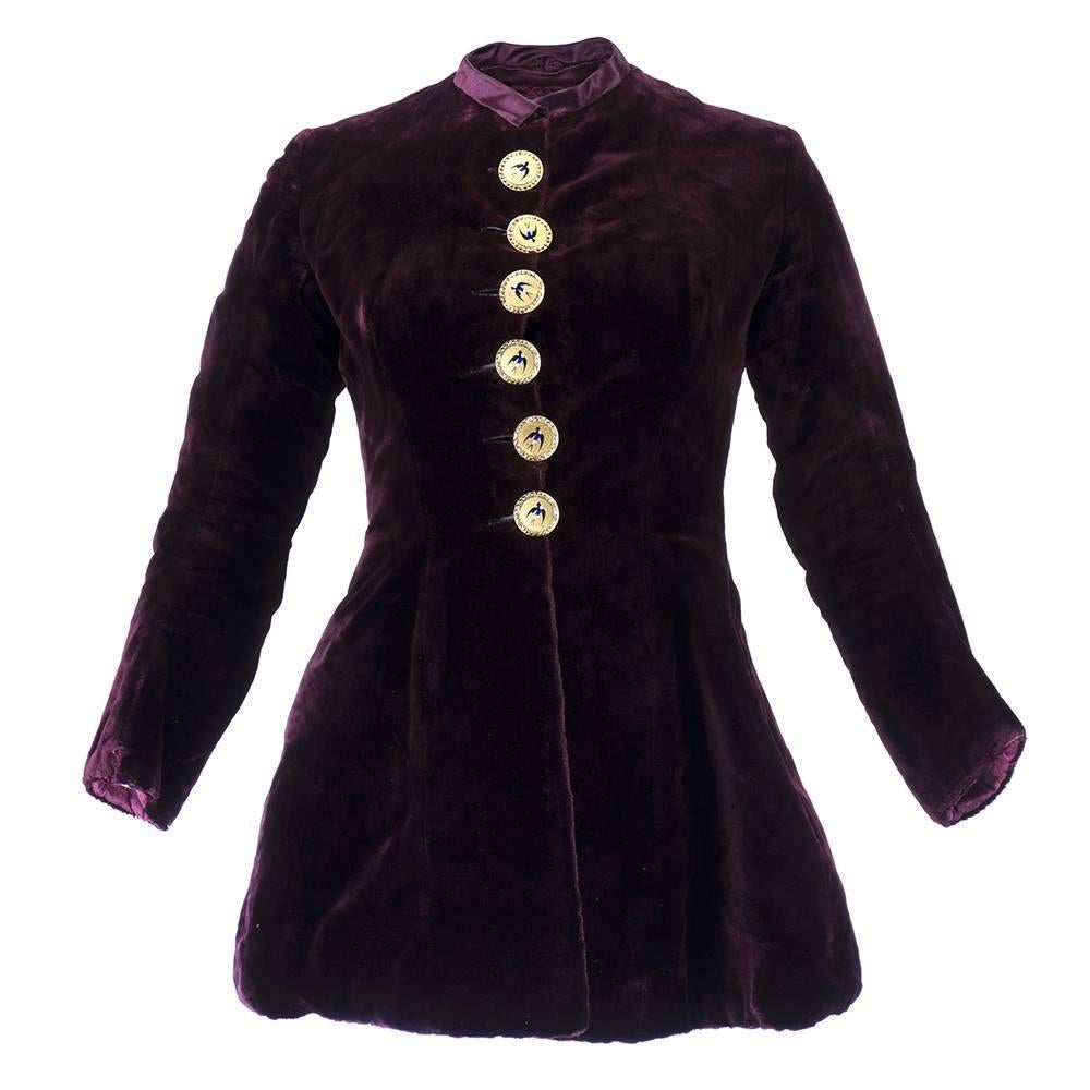 Wonderful example of Victorian style and craftsmanship. Stylized heavier weight plush velvet jacket with quilted lining and ornate buttons with bird motif in the high Victorian style. Vented and gathered back with high neck and snug fitting bodice.