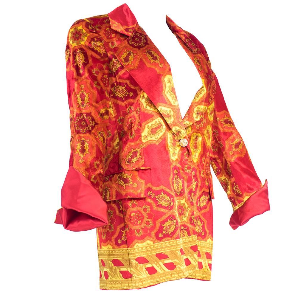 1990s classic blazer in silk velvet with exaggerated baroque paisley print in red, oranges and yellows. Extra long with flap cuffs and oversized collar. Fully lined.