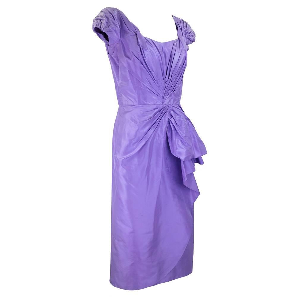 Classic 1950's Marilyn Monroe style wiggle dress by the master of the style Ceil Chapman.  Lilac silk taffeta strategically shirred in all the right places cascading down to a sassy hip flounce.