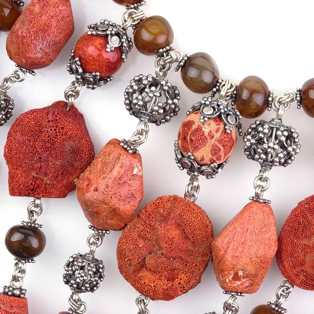 Stunning contemporary necklace by master jeweler Stephen Dweck. Sterling silver base with coral nuggets and amber colored beads. Highly dramatic with ascending drops of alternating beads and coral. True statement piece.