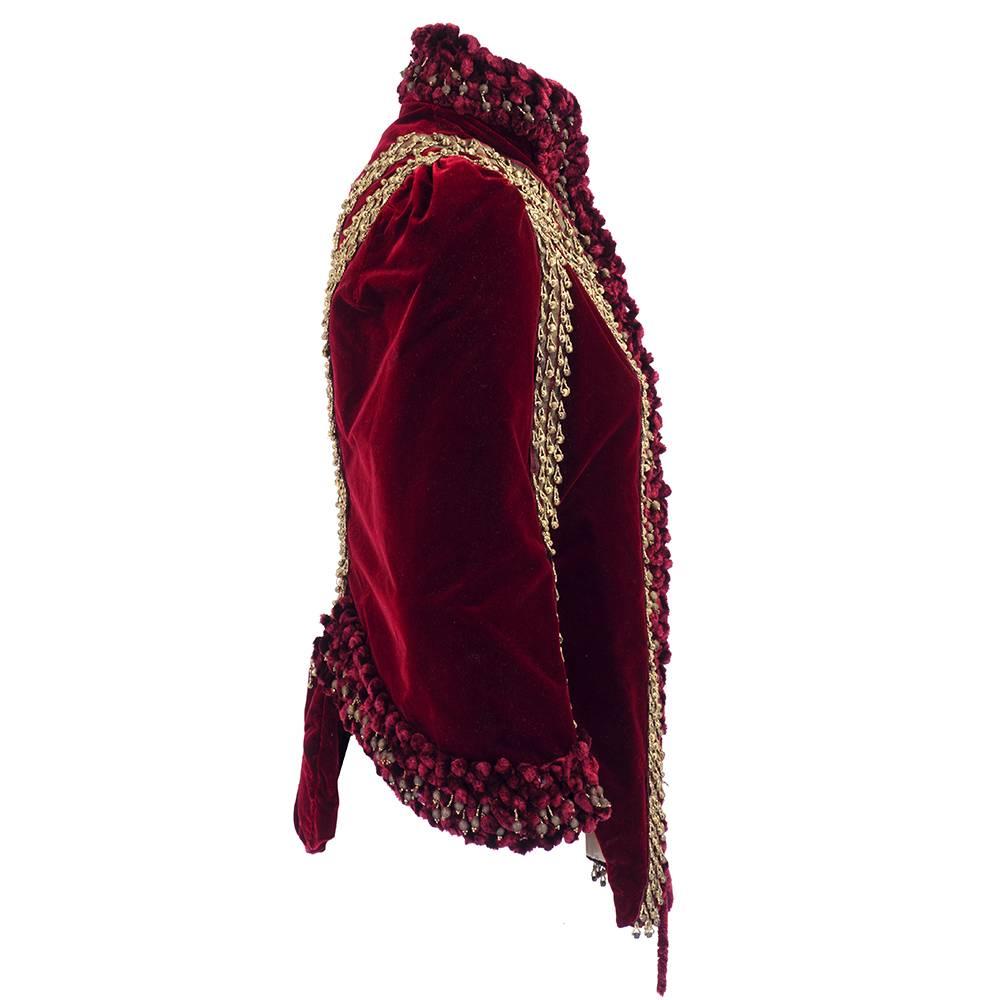 Lush and luxurious Victorian era carriage coat of deep burgundy velvet and buiillon trim. Made in France and heavily embellished with beads and chenille trim. Sight staining on champagne silk lining. Slight loss of buillion beads. Neither issue