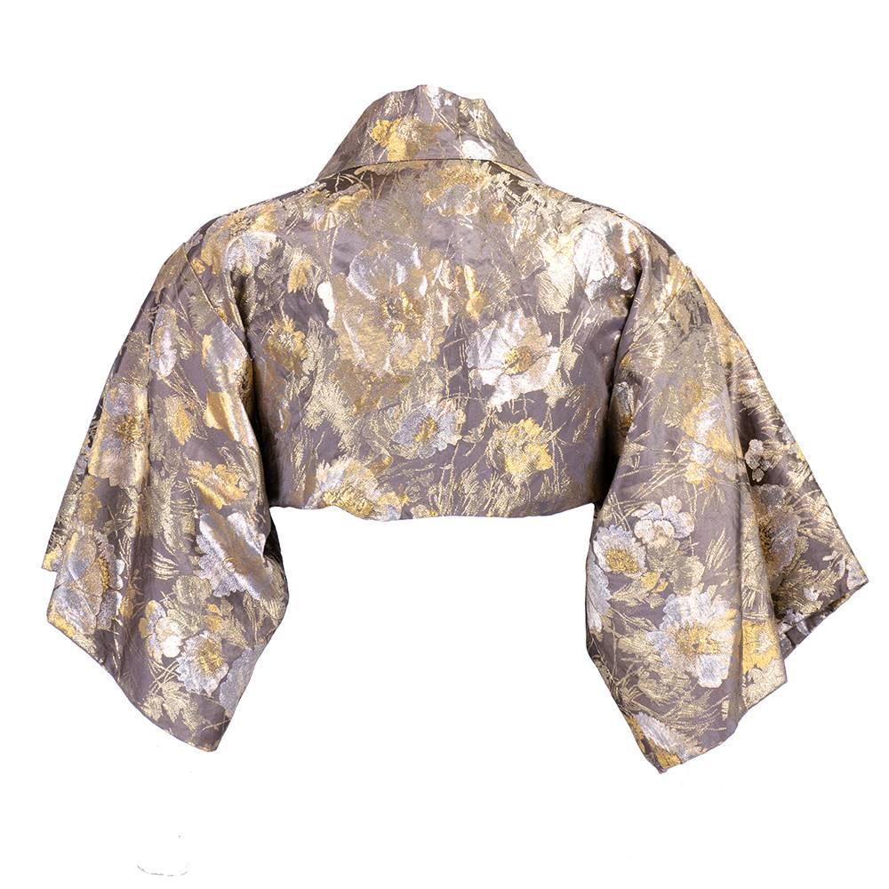 Stunning kimono style evening bolero by renowned academy award nominated  costume designer Howard Shoup. Beautifully tailored in gold brocade with floral motif. A true high style Hollywood classic - elegant and timeless. Measurements flexible due to