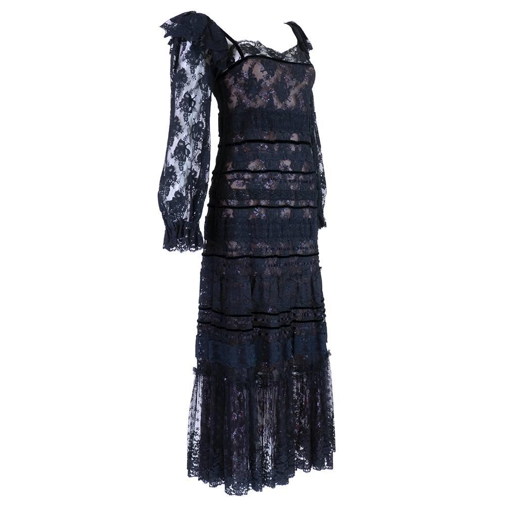Hippie luxe midi dress by the master Giorgio Sant Angelo. Tiers of black lace with an underlay of metallic lace. Fully lined with ruffles at shoulder and gathered wrists. Hook and eye closure down back. Great sexy peasant style.