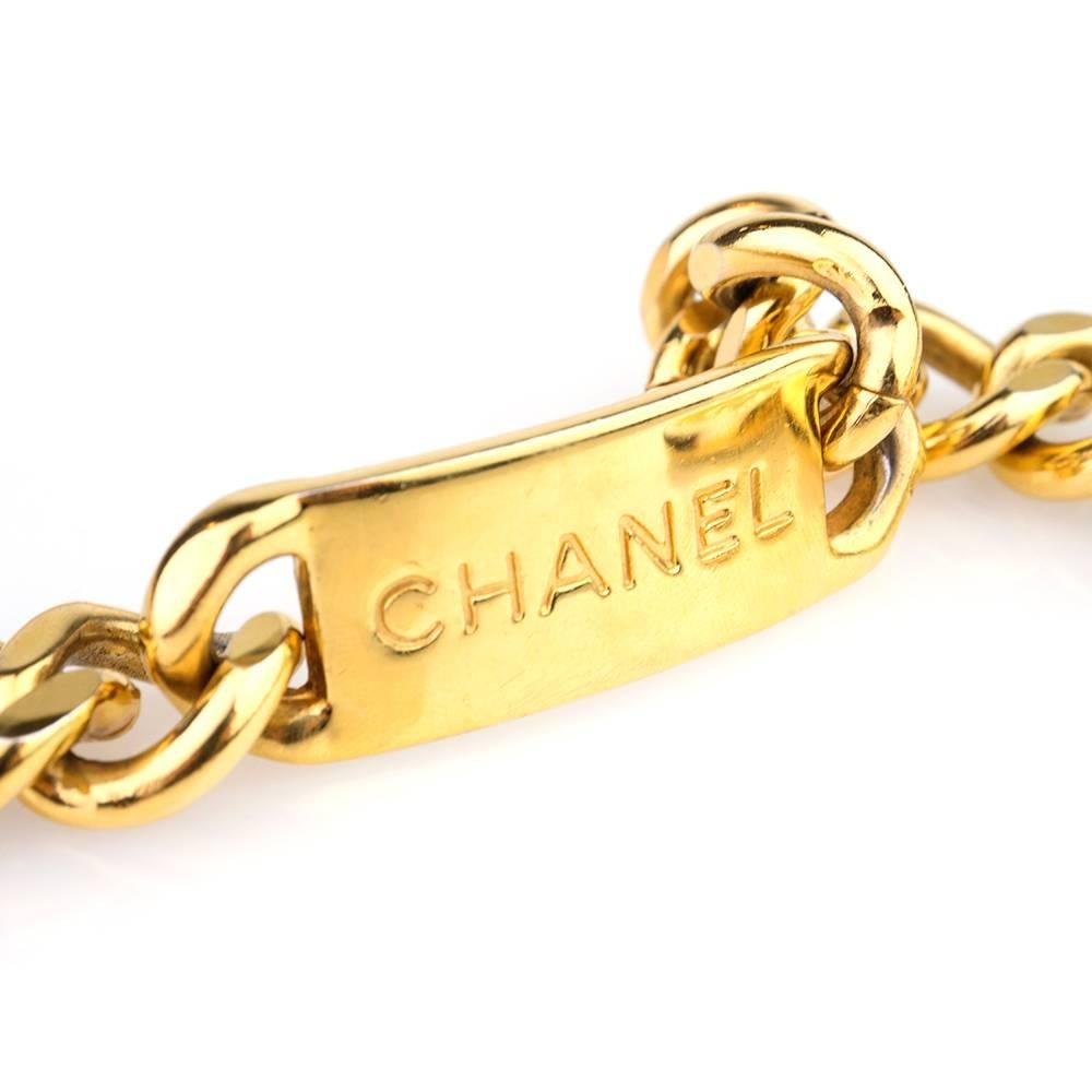 Fashion staple and perennial classic Chanel chain belt. Gold tone heavyweight chain with Chanel nameplate and dangling double C two tone medallion. Will fit up to 28