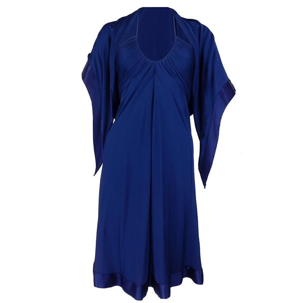 Sexy blue halter dress in heavy well draped jersey. Tie neckline with shirred bust line and flared skirt. Come with matching shoulder wrap. Both trimmed in coordinating satin. Stole is 60" wide.