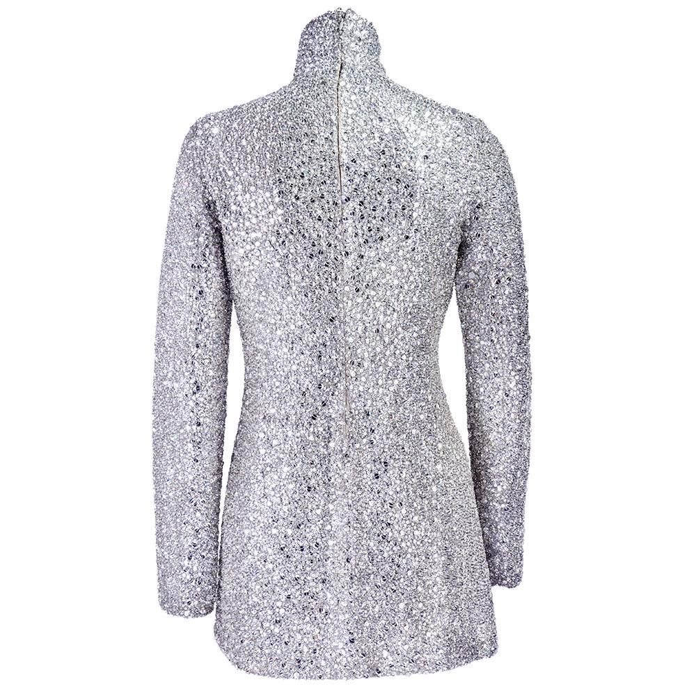 Super stunning allover crystal encrusted mini dress. Fully lined. High neck with full length sleeves.