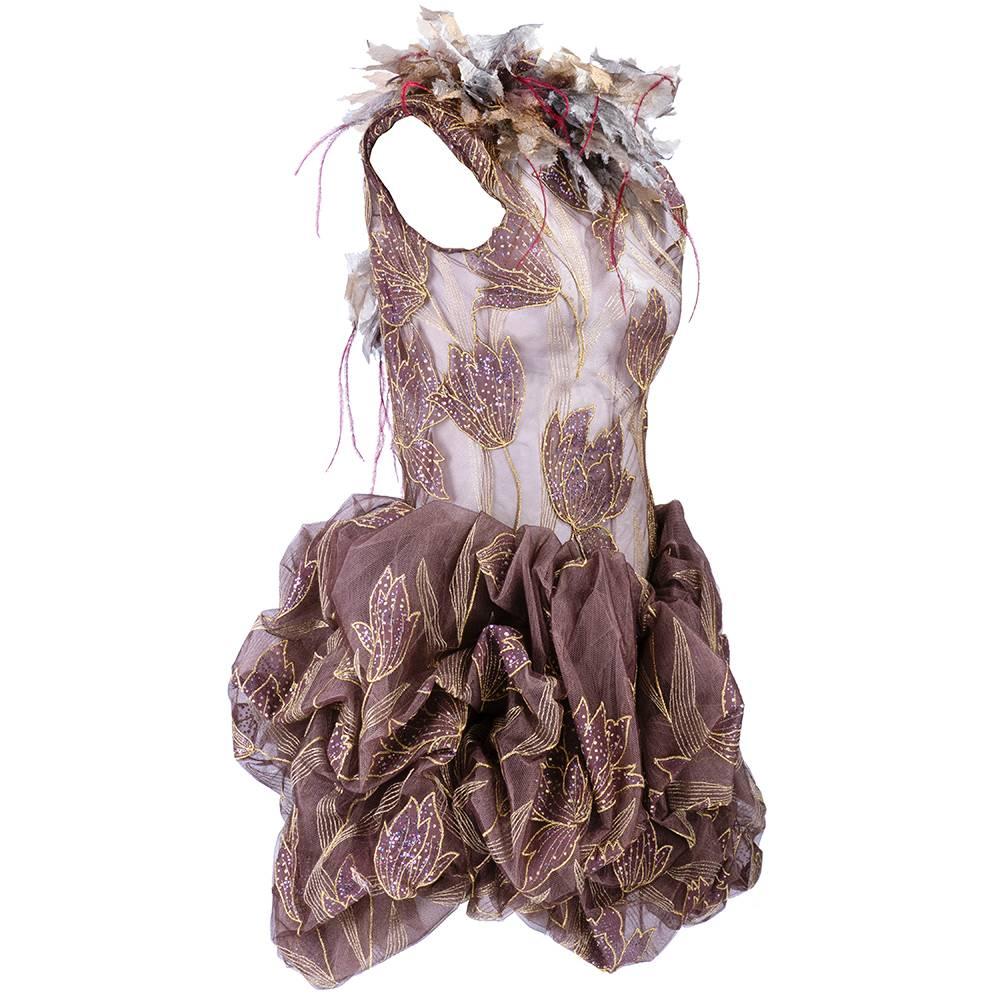 Incredibly constructed fantasy dress by unknown designer most likely 1990s. Light brown silk tulle with embroidery, feathers, embellishments . Sheer top with oversized raw edged ruff. Pouf mini skirt zips and buttons up back.  Pure fantasy piece -