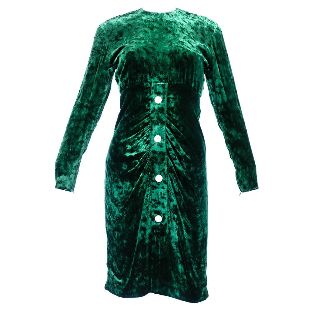 Gorgeous Christian Dior couture dress of green  velvet. Long sleeve, high neck with shirred front skirt. Rhinestone button accents down front and back. Fully lined in luxurious satin. Faux buttons - zips up back. Dates to Autumn-Winter 1984.