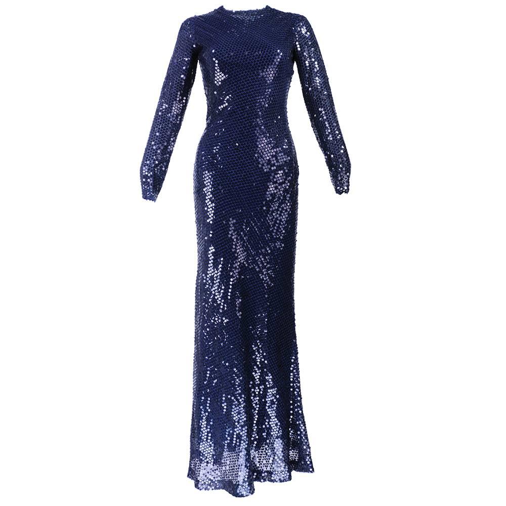 Classic full length mermaid gown by great American designer Bill Blass. Blue chiffon base with black sequins make for a very dramatic look. High neck, long sleeve with flounce at rear. Classic and sexy.