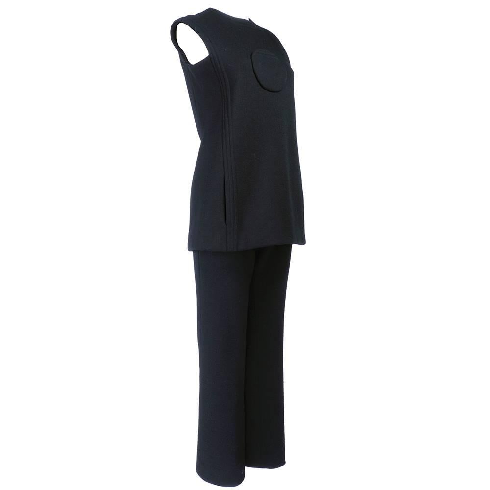 Super space age mod look from the 1960s by the master Pierre Cardin. Two piece  pant suit of sleeveless tunic with center front pocket and slash side pockets and flared, zip front elasticized waisted pants. Modern classic. Fully lined. About 1 1/2