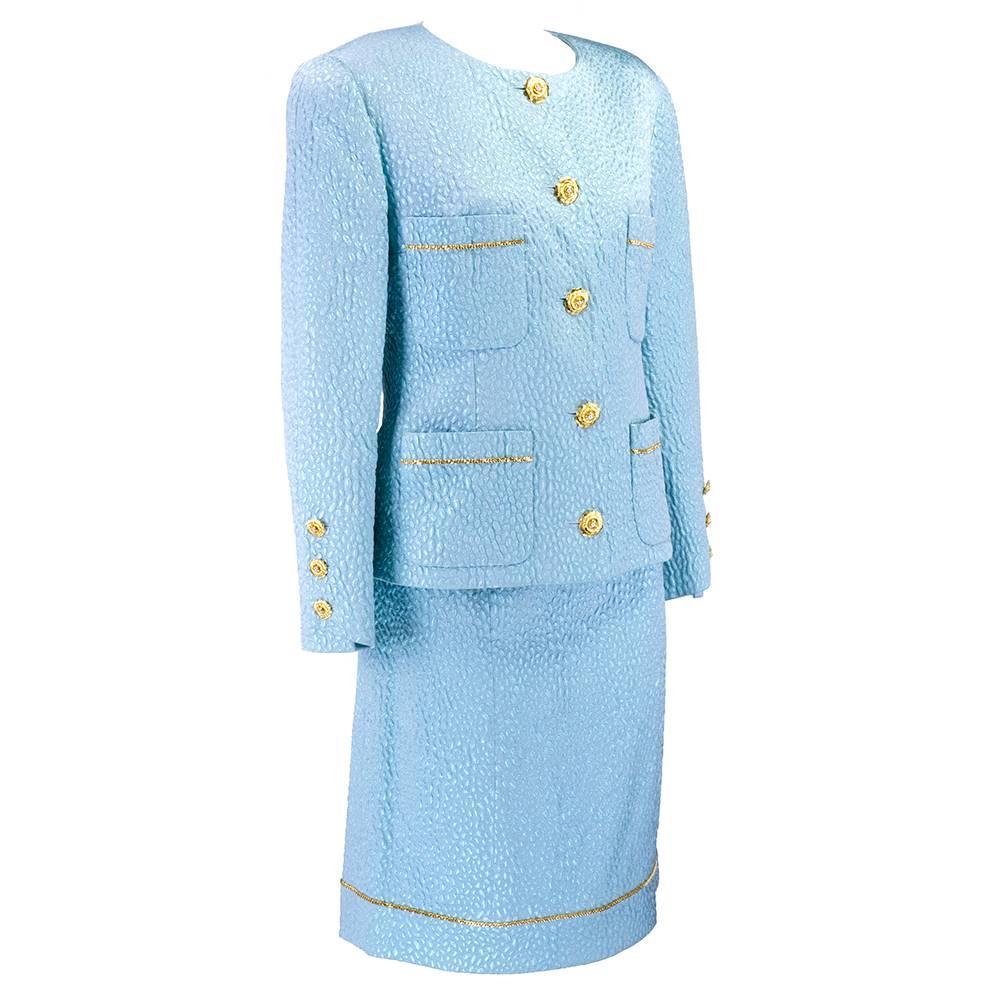 Classic Chanel suit in baby blue matelasse. Fully lined with signature gold chain trim. Beautiful Camellia gold tone buttons with pearl center. Patch pocket detail.

Skirt measurements: 
waist - 33