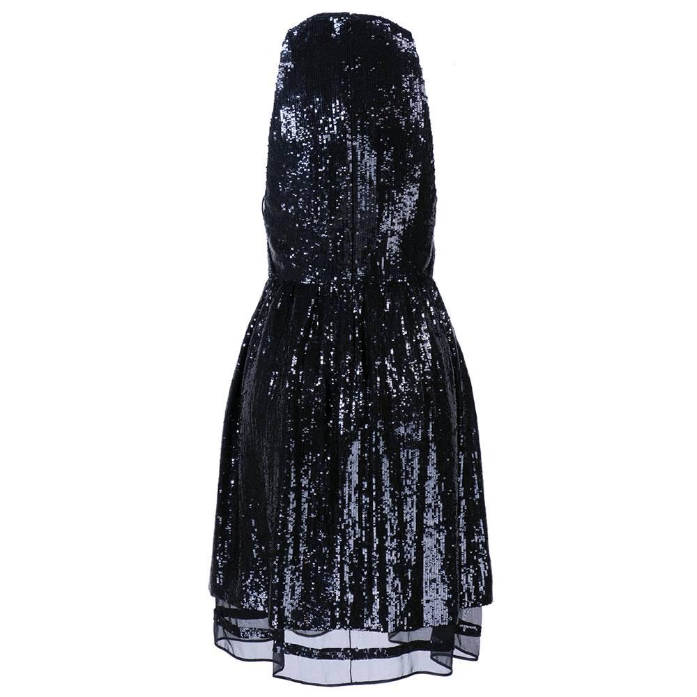 Sweet but sexy black cocktail dress completely covered in sequins with lace up detail at sides. Deep vee neck cut with gathered skirt with sheer silk underlay. Very light and swingy.