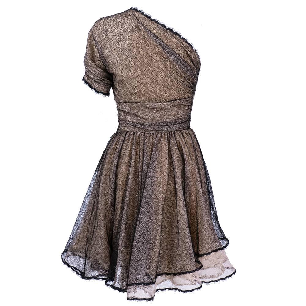 Wonderful, whimsical cocktail dress. Shirred one shoulder dress with full skirt. Black lace shot with metallic overlaid over nude lace.Fully lined. Delicate and romantic silhouette. Zips up side. Sweet yet sexy.