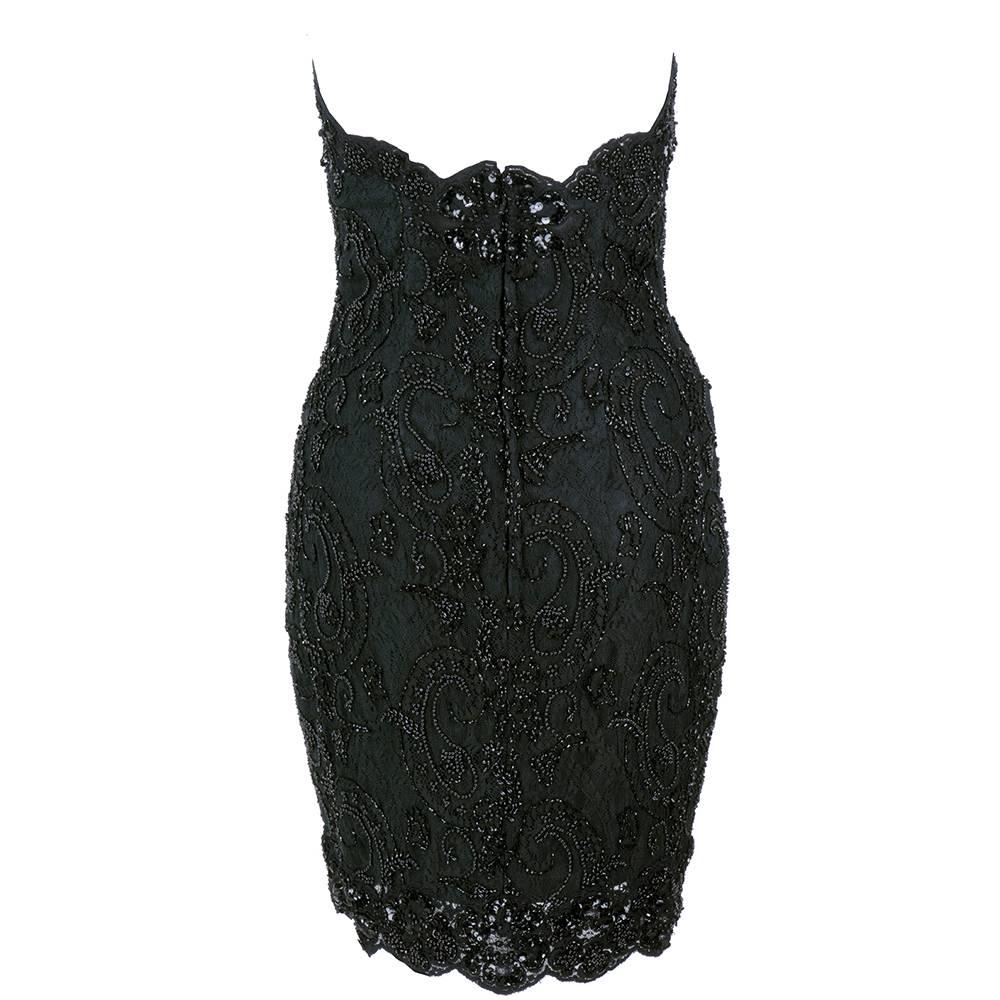Classic Vicky Tiel super sexy strapless cocktail dress. Black lace heavily beaded with sequins. With built in bra cups and boned bodice.Fully lined with diamond shaped peek-a-boo under bust. A PERFECT new years eve dress - especially if your ex is