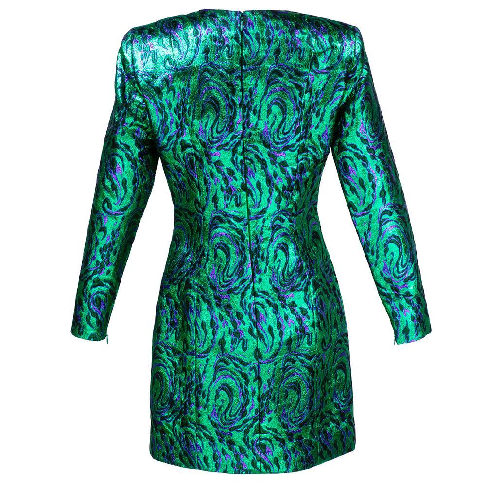 The most dramatic body con dress we've ever had. Designed by Givenchy circa 1980s. Green metallic jacquard in abstract pattern. High neck, long sleeves, padded shoulders and high cut hem make for a super sexy silhouette.