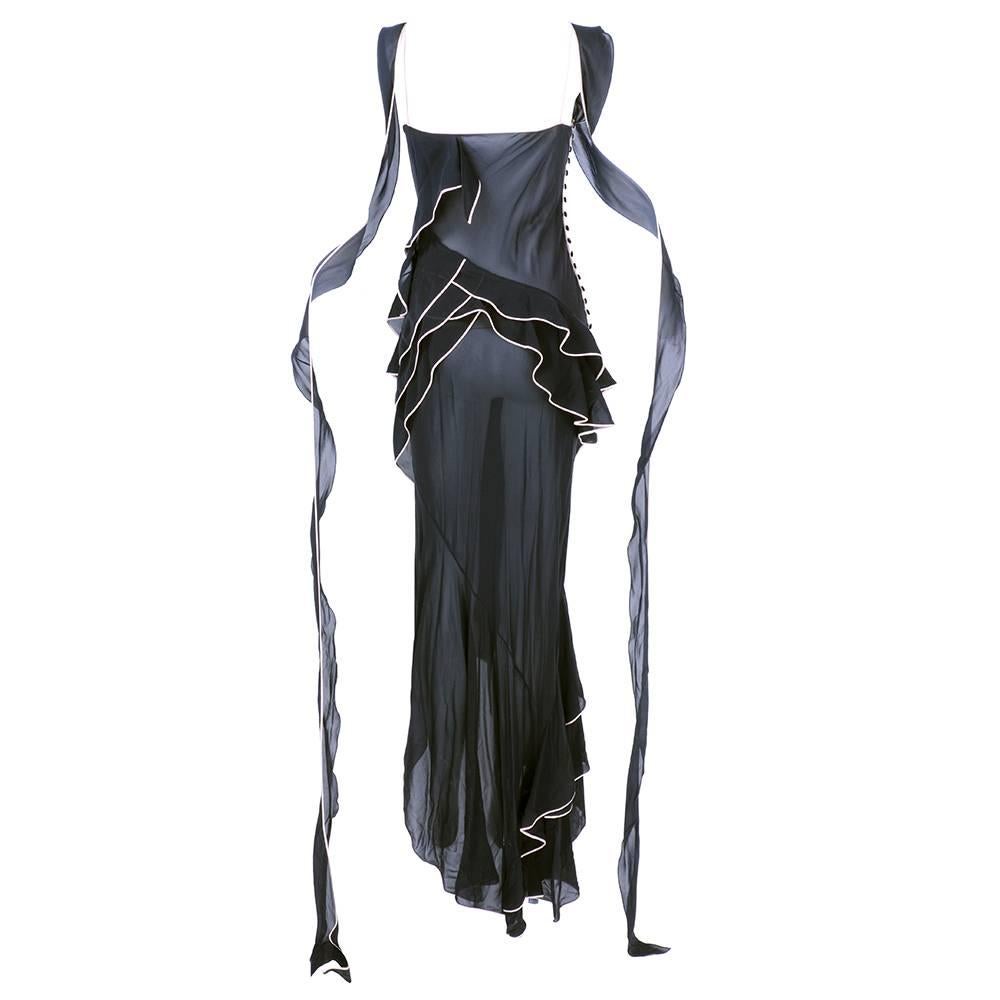 1990s gown of black chiffon bias cut with light pink trim. Asymmetrical ruffled trim make it perfect for dancing.  Attributed to John Galliano. Buttons down side - with cowled neckline.