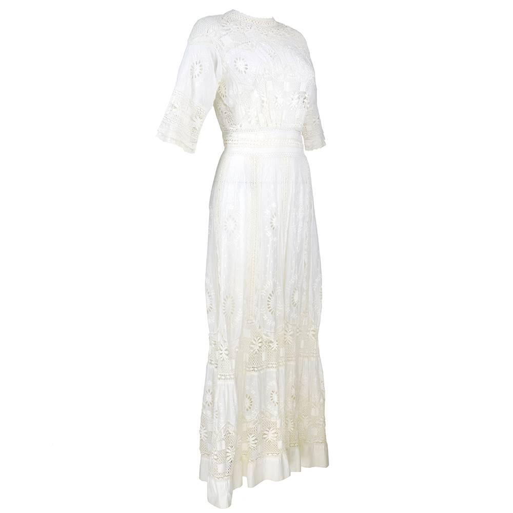 Edwardian lawn dress of sheer cotton with beautiful embroidery, eyelet and crochet lace. High neck with three quarter sleeves. Buttons up the back with hook and eyes at waist.