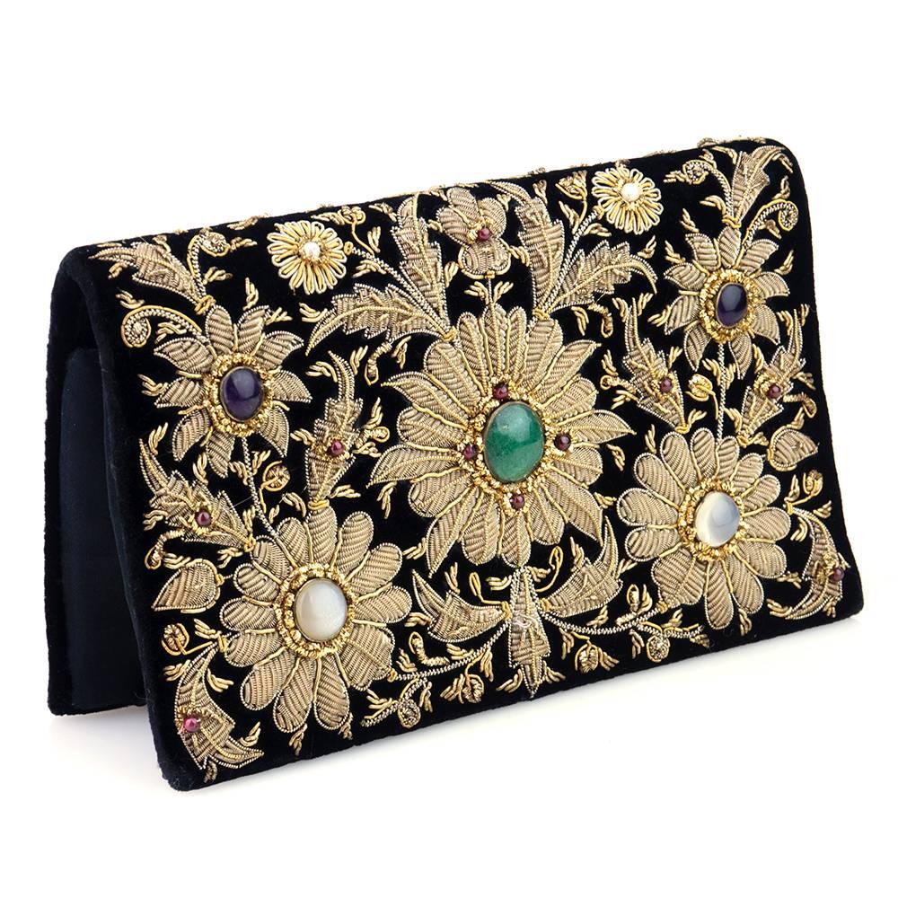 Gorgeous velvet flap clutch with snap closure from India.  Gold bullion braid embroidery surrounding semi precious stones (adventurine, moonstone, amethyst, garnets and pearls). Fully lined. 