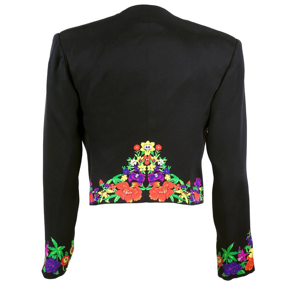 Lifetime Gianni Versace little black cropped jacket of 100% silk. Edged in multi color floral print. Fully lined with open front and light shoulder pads.
