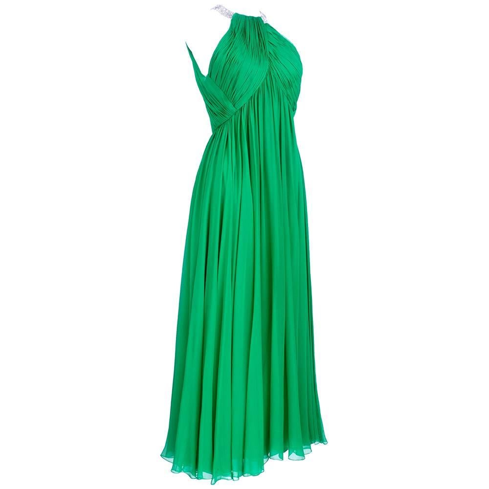 Grecian style goddess gown in emerald green chiffon by Elinor Simmons for Malcolm Starr. Neck encircled by a collar of rhinestones. Shirred at bust with empire waist. Fully Lined. Beautiful tea length dancing dress. 