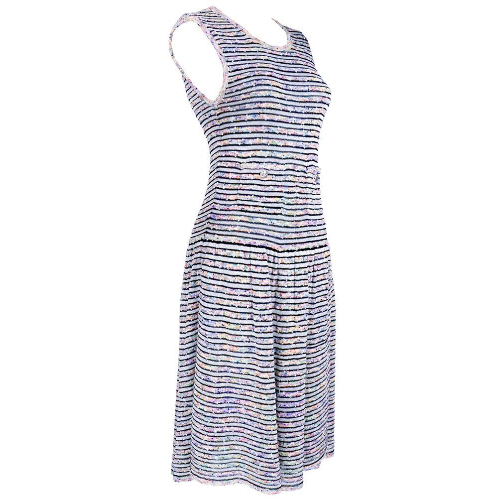 Adorable  dress by Chanel. Stretchy, striped, sleeveless with flared wrap skirt. Pockets at waist with silvertone buttons. Fun confetti colored nubby woven fabric. 

Some flexibility in sizing due to stretch.