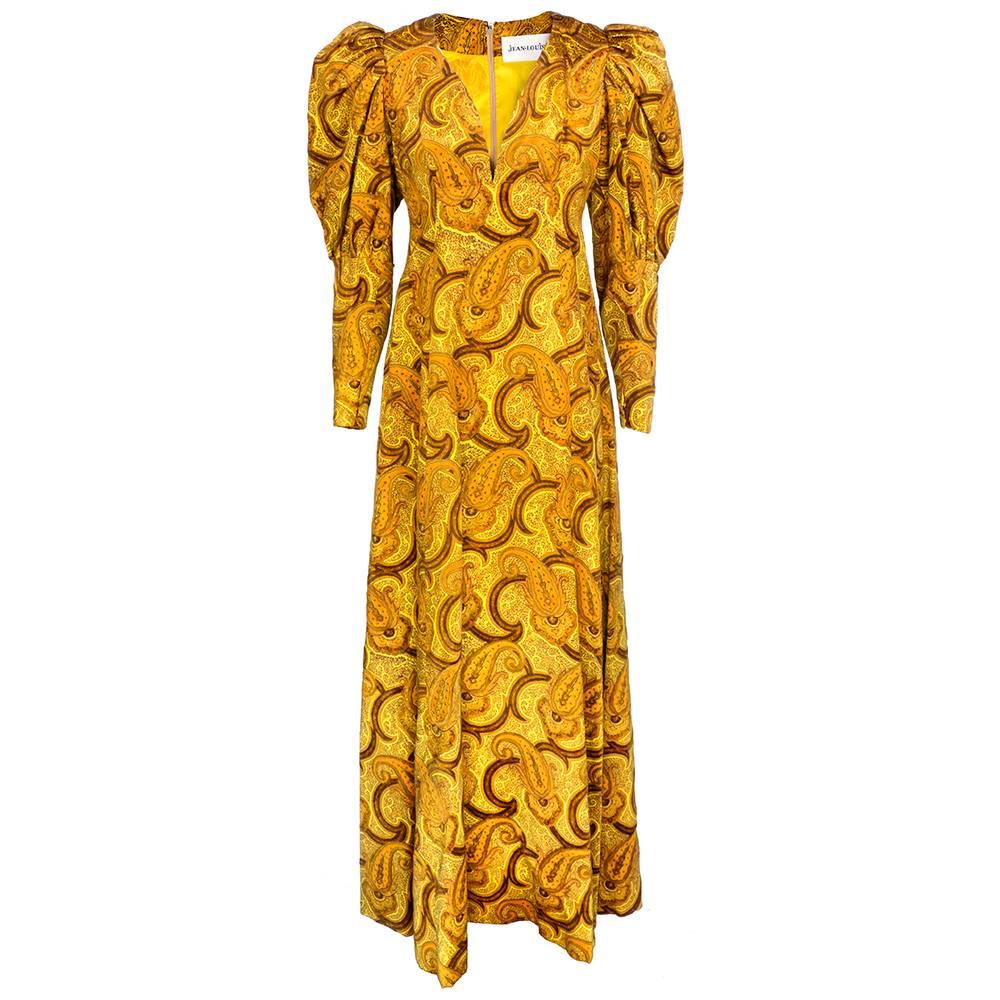 Stunning Jean Louis gown from the 1960s by famed designer Jean Louis and owned by screen star and his wife Loretta Young. Dated 1966, this gown of golden devore velvet  in a paisley motif has full puffed sleeves and comes with matching turban. Gown