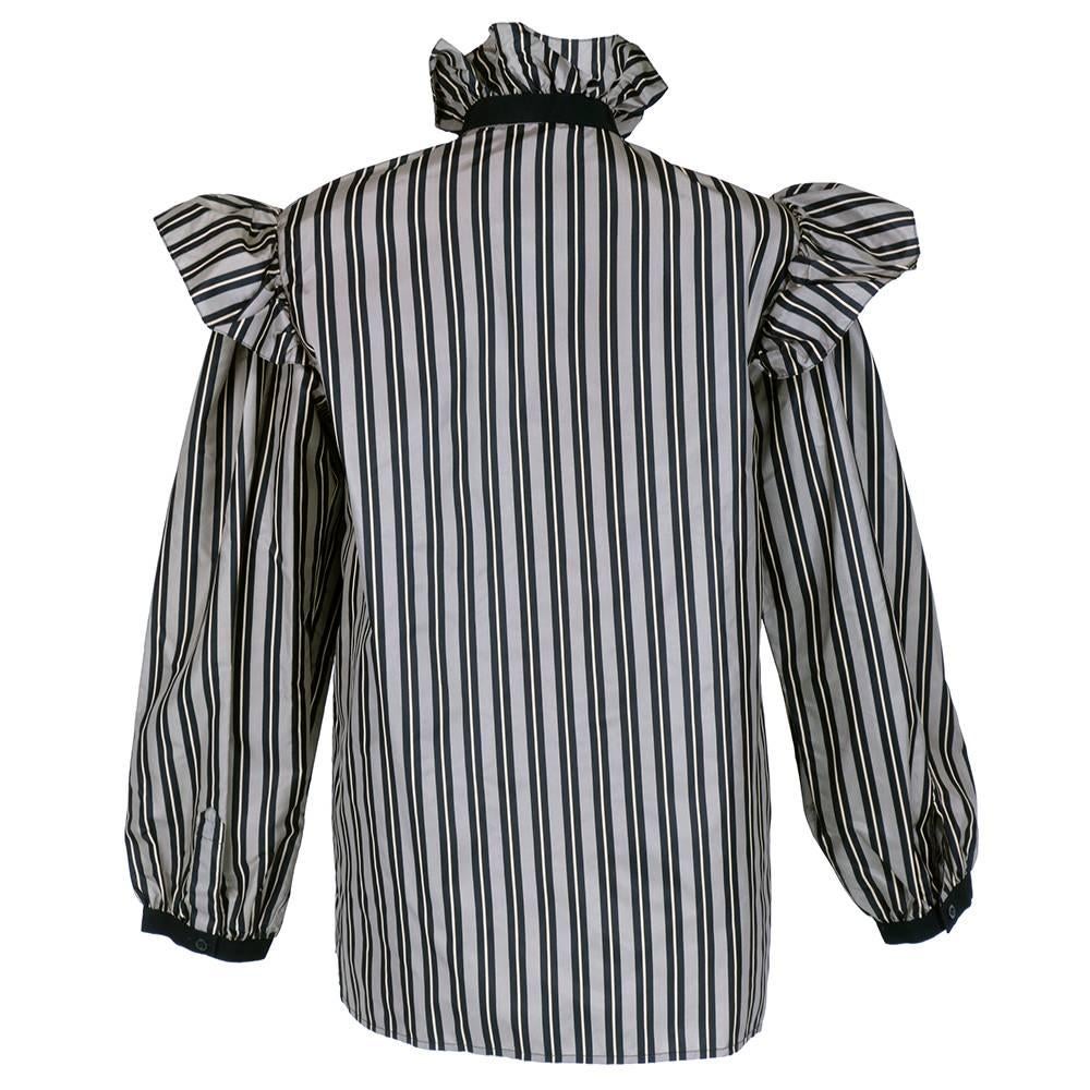 Saint Laurent strikes again with another perennial favorite - The ruffled silk taffeta blouse. Stripes in Black and grey. Buttons down front with full sleeves and gathered wrist. Attached grosgrain ribbon bow. Ruffles everywhere!