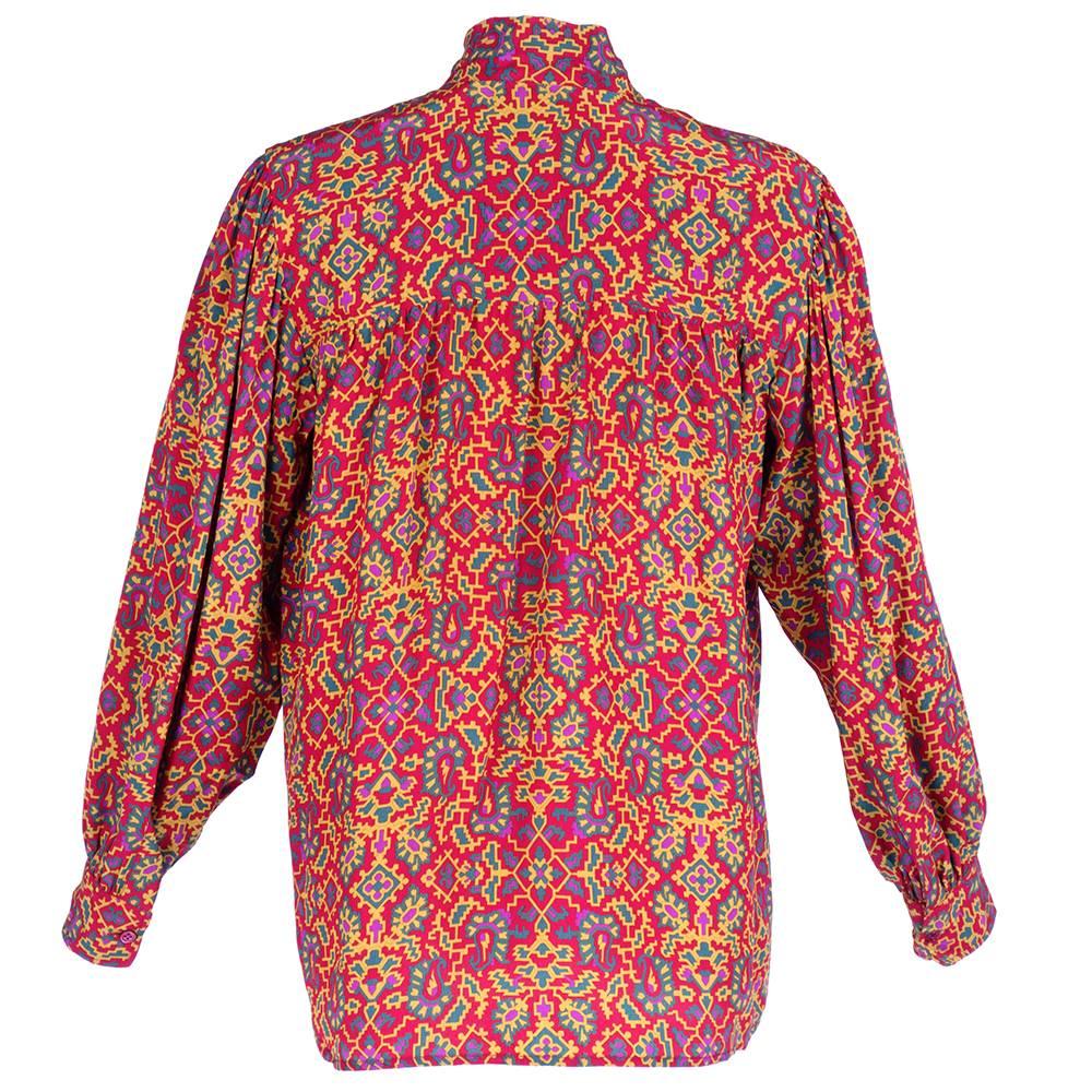 1980s pussy bow blouse by YSL circa 1970s. Red silk with abstract paisley print. Buttons down front. A classic.