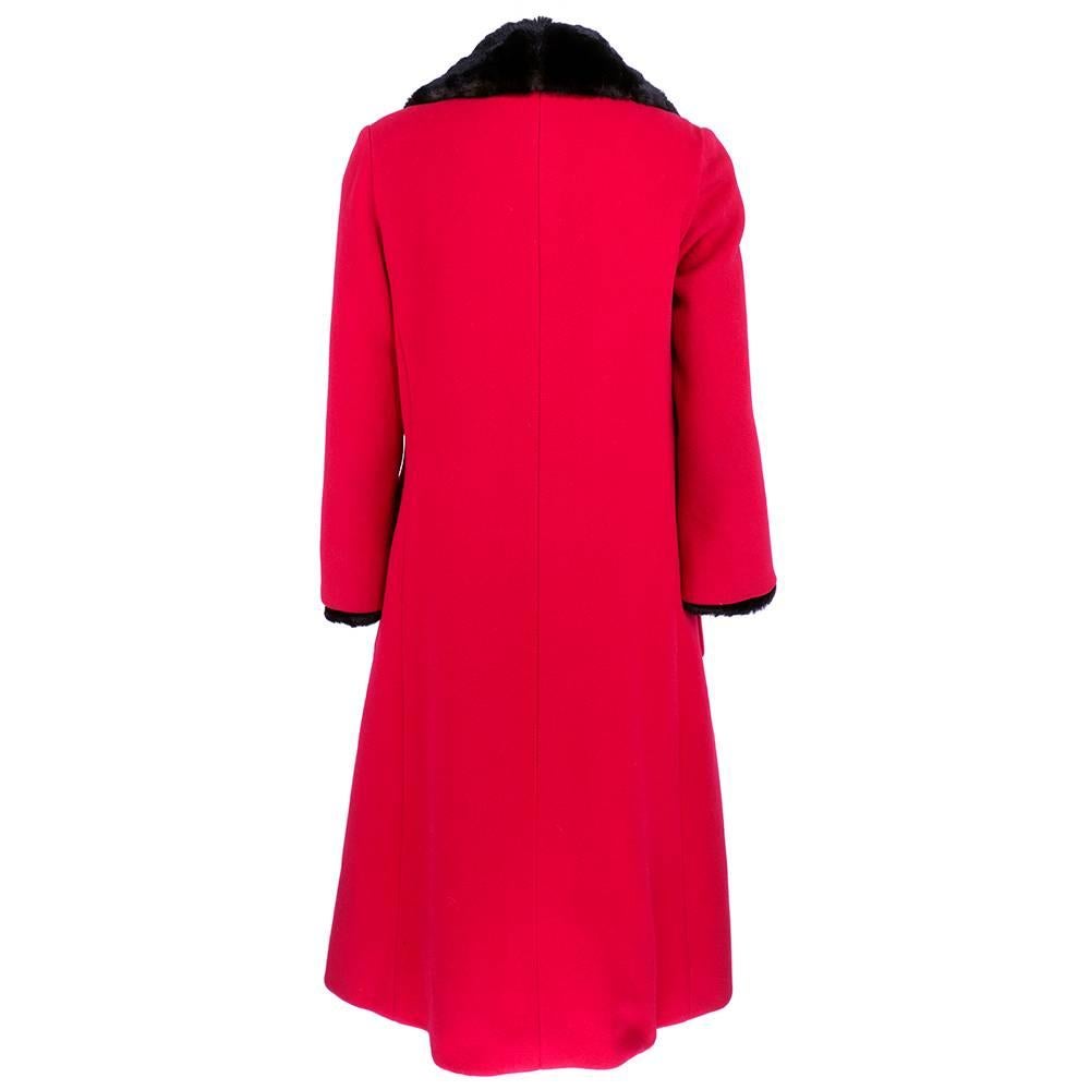 Dramatic Haute Couture coat by esteemed french designer Pierre Balmain. Heavyweight red wool topcoat with oversize patch pockets. Fully lined in sheared beaver.