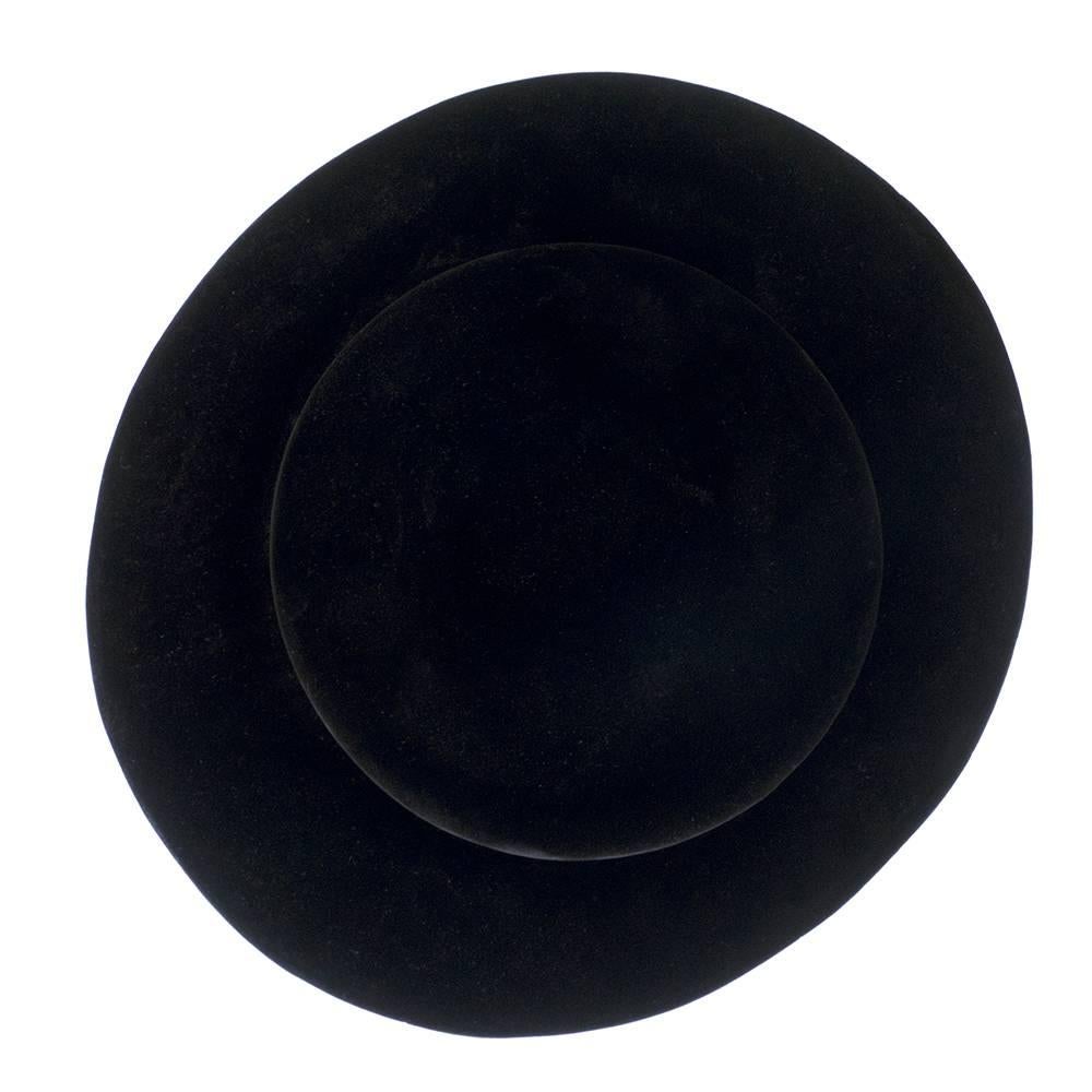 Statement hat by iconic designer Halston circa 1960s. Oversized black velvet platter lined in gold lame. Super chic and collectable. Fits medium size head,