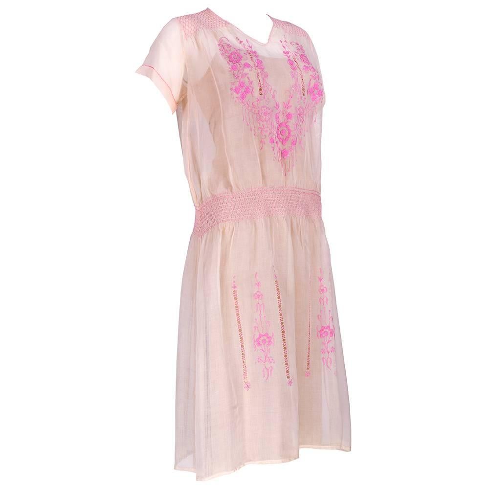 Classic peasant styling on 1920s pink cotton hand smocked dress. 