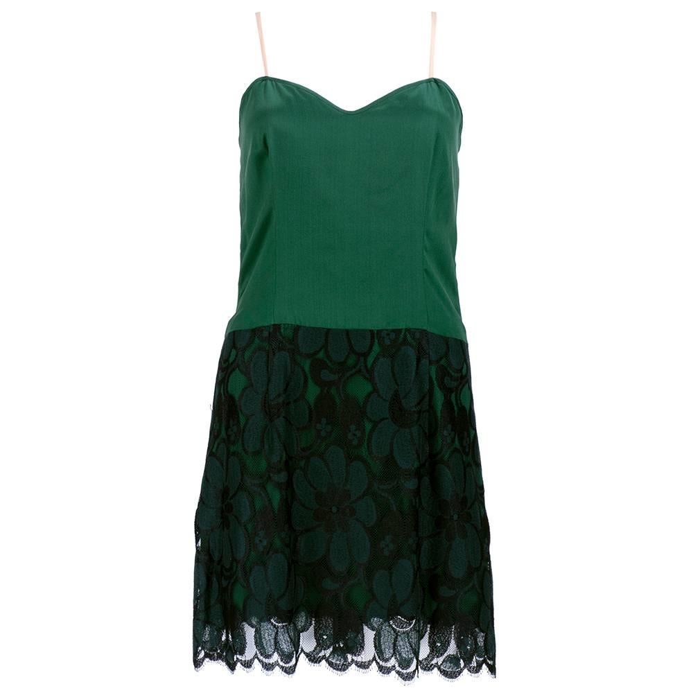 1980s with the look of 1960s cocktail dress consisting of overblouse and slip top mini dress. Dramatic green to black lace. Simple yet sexy.