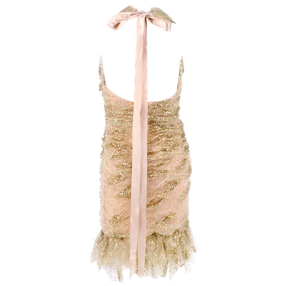 90s body-con mini dress by Oscar de la Renta  in ivory tulle festooned with mini gold sequins. Fully lined halter neckline with satin bow. Petalled handkerchief hem. Fully ruched. Award show worthy.