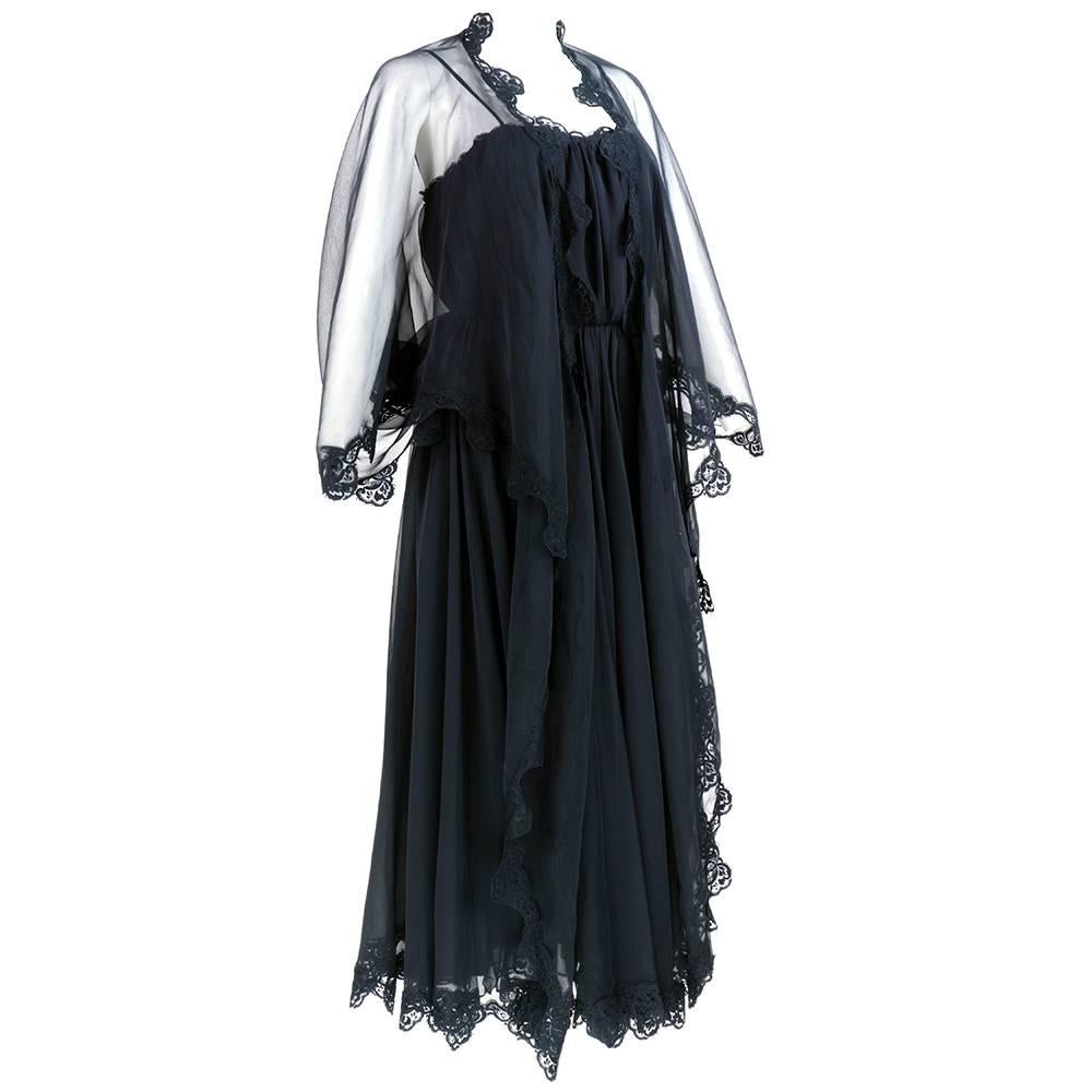 Super boho high-style hippie maxi dress in black chiffon trimmed in black lace by British designer Frank Usher. Peasant style with attached wraparound shawl. Fully Lined and zips up side.