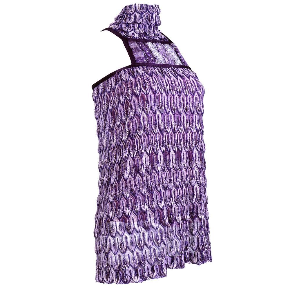 Signature zig zag motif Missoni knit in lavender to metallic purple. Micro mini with mock turtleneck and sequin embellished plaque at neckline. Buttons at back of neck Fully lined. Sexy and fun.
