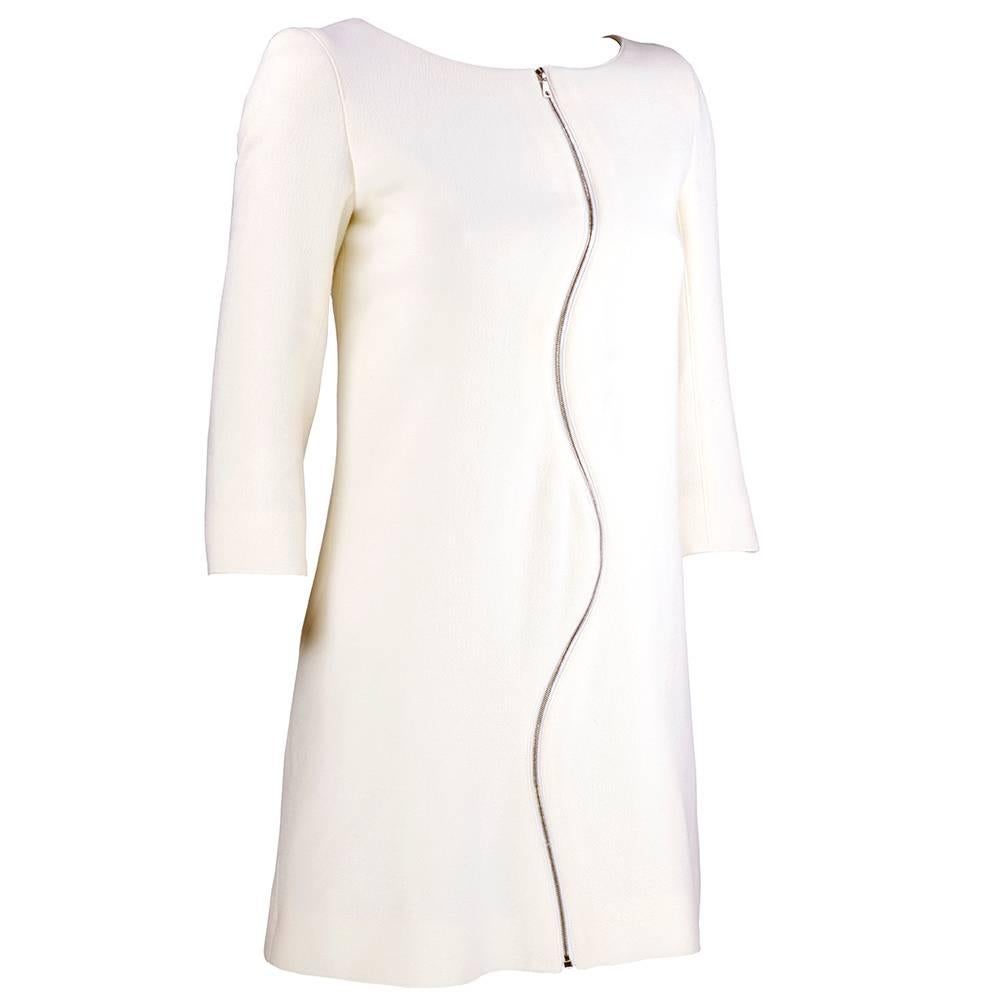 Contemporary redux of classic Courreges styling. Lightweight ivory wool blend mini shift with undulating zippers at both front and back. Fully lined with 3/4 length sleeves.