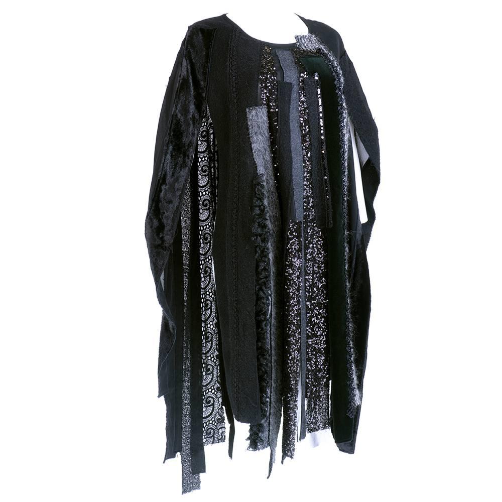 Tabard style pullover poncho by Junya Watanabe constructed of vertical strips of wool, velvet, sequins and other materials on a base of rayon chiffon.  Slips on over head. Uneven hem. Tag size small - one size should fit small to large. 