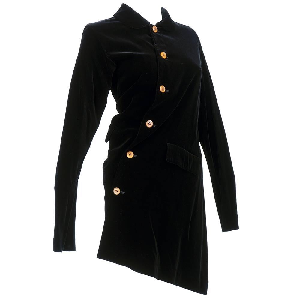 Wonderful avant garde jacket with asymmetrical tailoring. In black velvet with amber colored buttons. Unlined with rounded collar. Circa 2002.