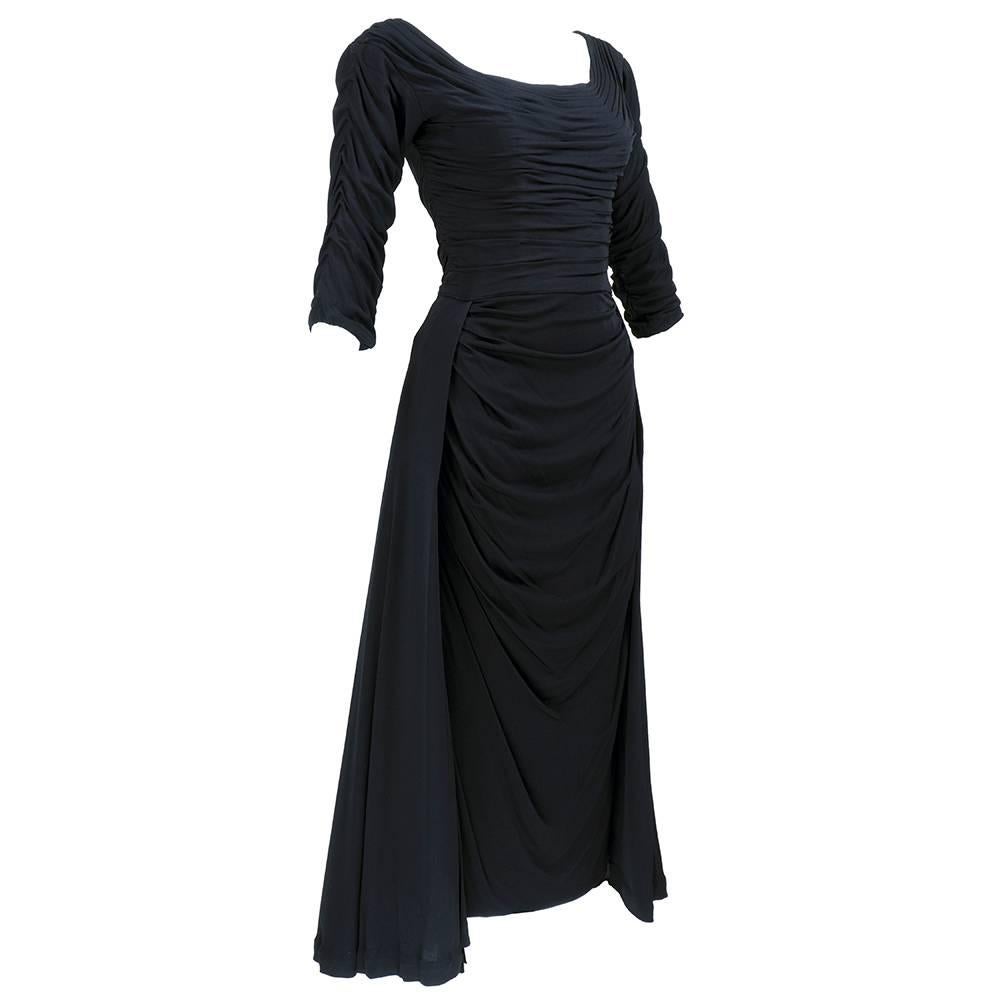 The very best Ceil Chapman dress ever! . Black jersey draped to perfection. Gathered bodice, draped underskirt with open front overskirt stiffened to stand out away from the body. Slinky and sexy.  Back dips loowwww!


Just reduces the price by $300